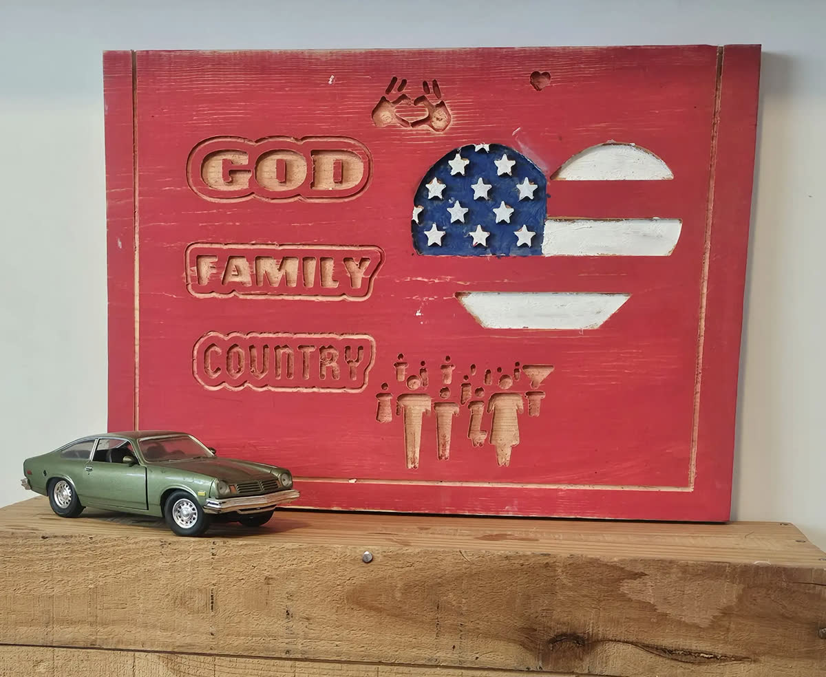 Handmade red wooden sign celebrating God, family, and country